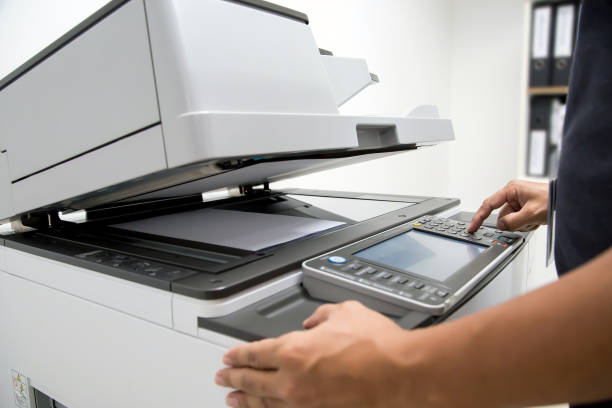 istock Businessman press the button using the photocopier or printer is office worker tool equipment for scanning document and copy paper. 2196116777
