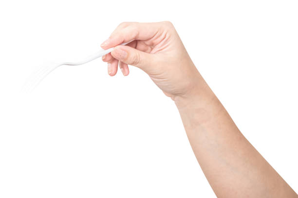 istock Female hand holding a white plastic fork isolated on white background 2196116886