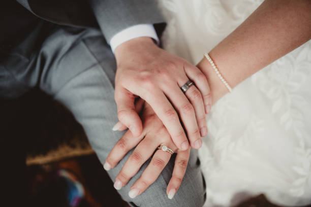 Bride and groom husband and wife close up of wedding rings Man and woman with hands showing off engagement ring and wedding band hands of bride and bridegroom in wedding marriage ceremony stock pictures, royalty-free photos & images