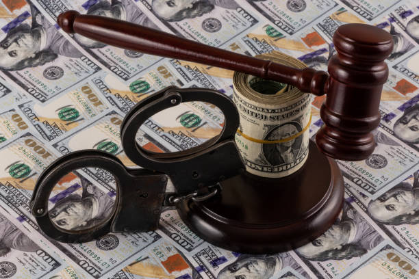 istock Handcuffs, judge's gavel and $100 bills 2196119369
