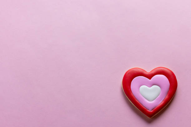 istock Handmade heart-shaped cookie with red, pink and white colors. 2196120097