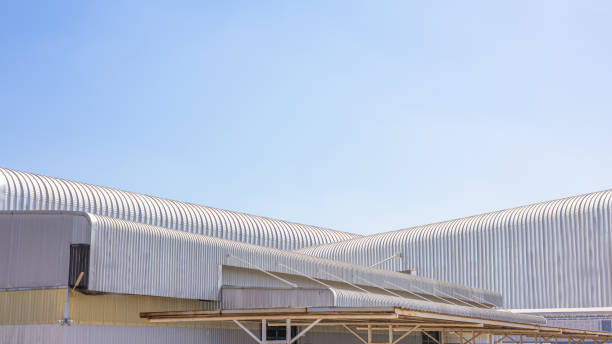 istock Factory industry, Modern geometric warehouse, Corrugated metal texture background, Architectural building wall with aluminum siding on blue sky background, Stackable warehouse roof, Metal sheet roof. 2196122643