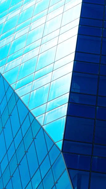 istock A modern building facade showcasing reflective blue glass panes arranged in diagonal and geometric patterns. 2196126093