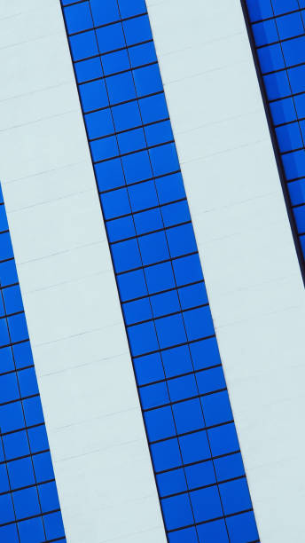 a bold architectural design with a striking interplay of blue and white geometric patterns. The use of symmetry and clean lines highlights the building's modern aesthetic, creating a visually compelling composition.