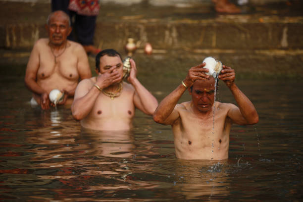 Nepalese Hindu devotees are offering ritual prayers during  the Madhav Narayan Festival, or Swasthani Brata Katha festival, at the Hanumante River in Bhaktapur, Nepal. The festival is dedicated to God Madhav Narayan and Goddess Swasthani, where Hindu devotees are recreating and reciting folk tales about miraculous feats performed by them.