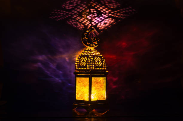 istock Lantern with moon symbol on top with colorful light shadow background. 2196126710