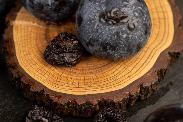 istock ripe purple plums and dried plums 2196129136