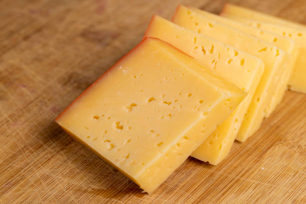 istock hard cheese with holes on the cutting board 2196129166