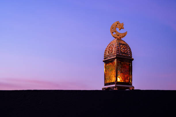istock Golden lantern that have moon symbol on top with dusk sky background 2196129719
