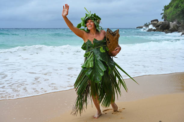 Robinson Crusoe woman dressed in palm branches on the Indian Ocean coast