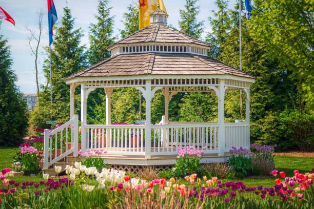 istock Charming white gazebo in a vibrant garden. 2196132130
