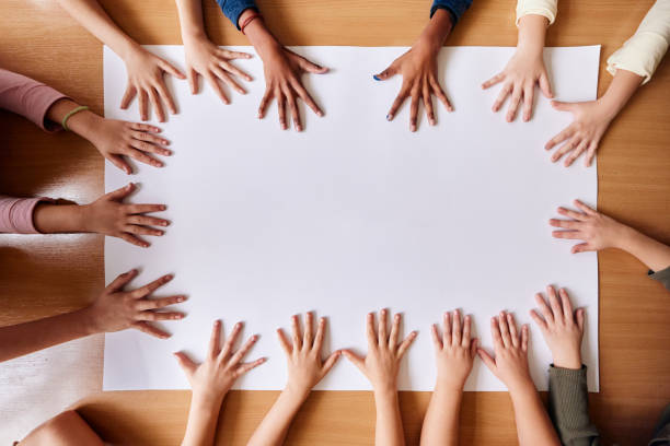istock Kids' hands on blank white placard at school! 2196132567
