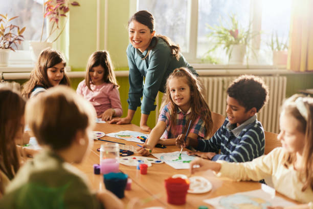 istock Happy teacher having an art class with her students at elementary school. 2196132700