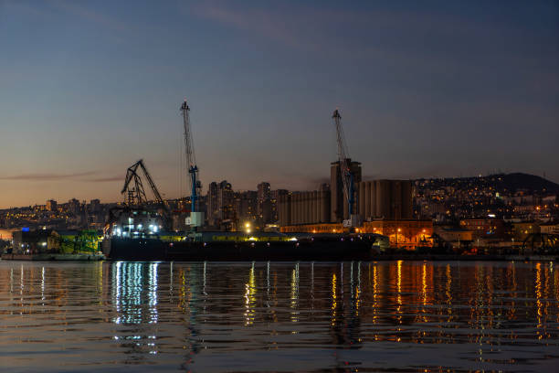Large cargo ship anchored in the harbor, photographed in the evening