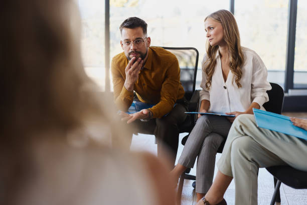 istock Depressed businessman talking on a group therapy in the office. 2196136033