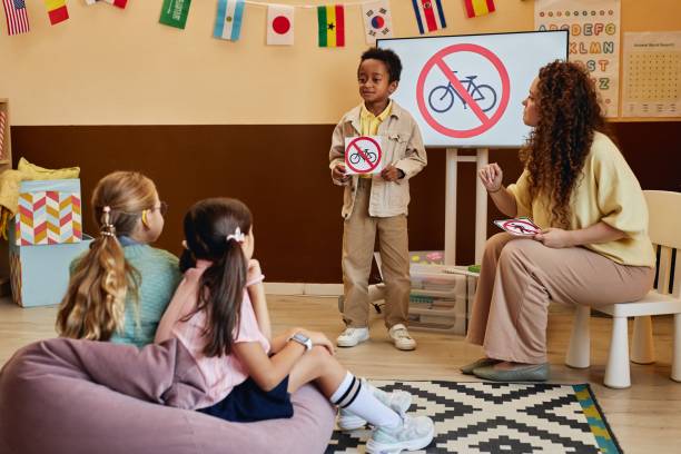 istock Boy Holding Sign Presenting Road Safety Rules 2196136643