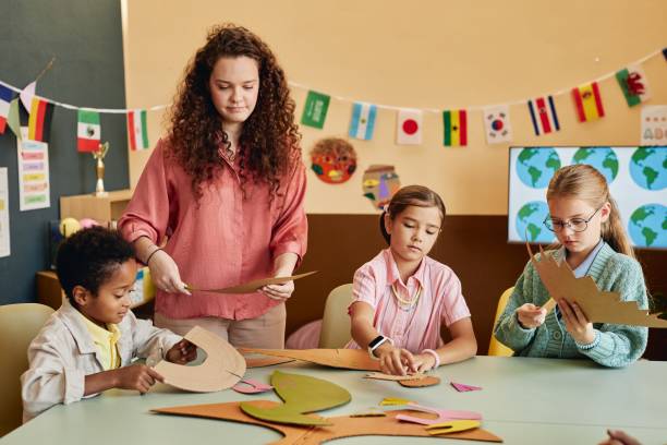 istock Teacher Assisting Kids during Art Craft Class in School 2196136655