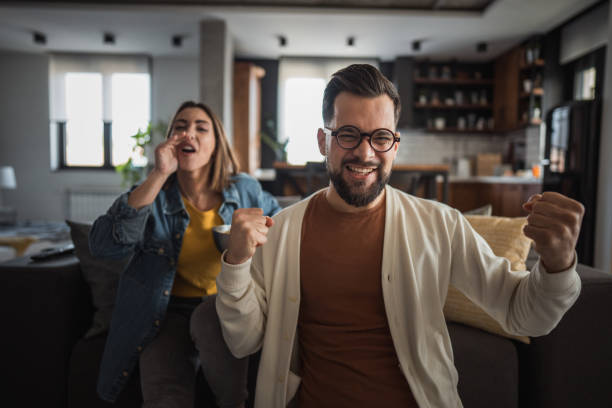 istock Happy couple watching a match and celebrating together 2196137540