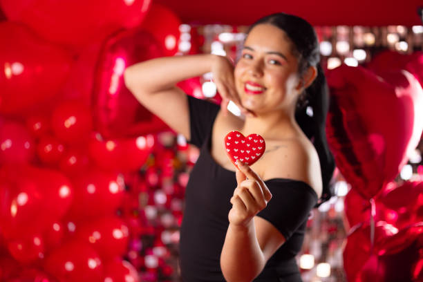 istock Beautiful young woman posing with a heart cookie 2196138161