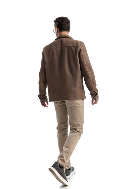 istock back view of young man walking and looking to side 2196143524