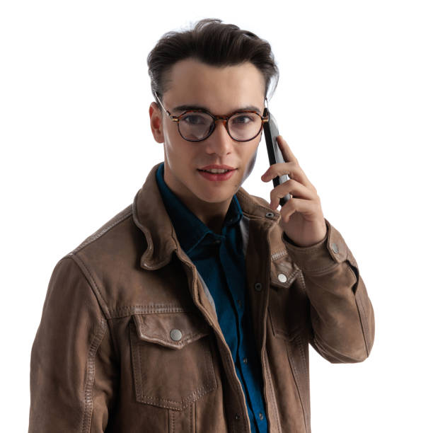 istock handsome young man with glasses speaking on mobile phone 2196143743