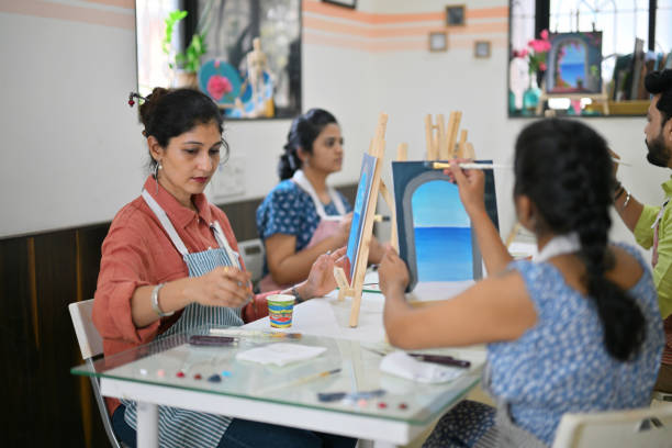 istock Adults immersed in a canvas painting class 2196144356