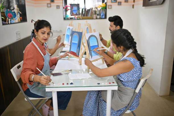 istock Participants engaged in canvas painting during a workshop in an art studio 2196144370