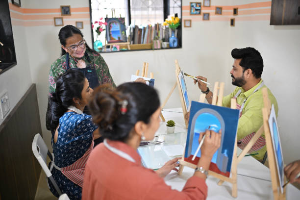 istock Passionate woman artisan observing participants during a canvas painting workshop 2196144382