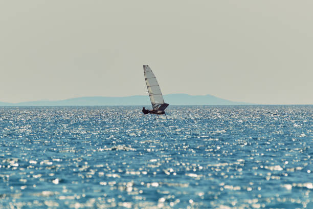 Windsurfing in the Mediterranean Sea off the coast of Mykonos Island in Greece
