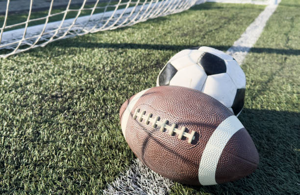 istock soccer ball and rugby ball, space for text 2196144729