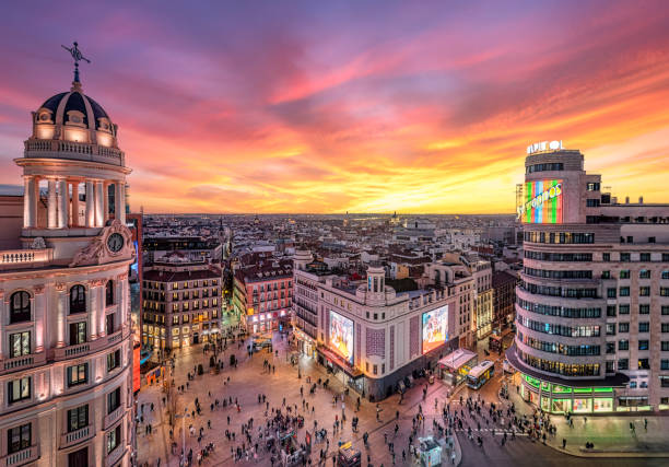 zářivý západ slunce nad gran vía a náměstím callao, madrid, španělsko - madrid - stock snímky, obrázky a fotky
