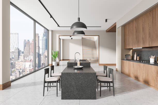 istock Modern kitchen interior with sleek granite island and wooden cabinetry in open space overlooking cityscape through large windows. 3D Rendering 2196144838