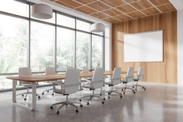 istock Modern conference room with wooden paneling, large windows, and blank whiteboard on the wall. 3D Rendering 2196144974