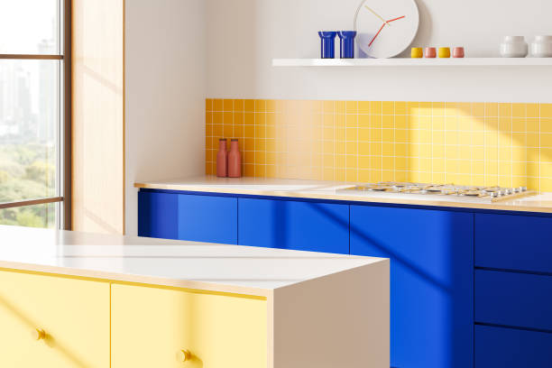 istock Modern kitchen interior with vibrant blue and yellow cabinets and tiled backsplash. 3D Rendering 2196146303