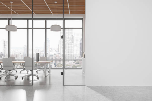 istock Empty white wall mockup in a modern office with large glass windows and cityscape view in background. 3D Rendering 2196146318