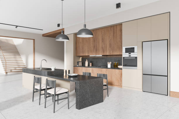 istock Modern kitchen interior with wooden cabinetry, black granite countertop, dining area, and minimalistic lighting fixtures. 3D Rendering 2196146484