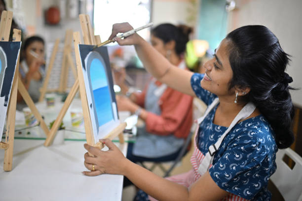 istock Woman enjoying her canvas painting during a creative workshop 2196150491