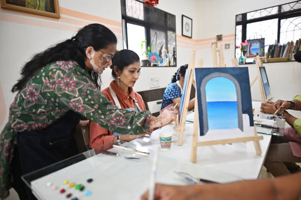 istock Skilled artisan passionately teaching canvas painting in a creative studio 2196150492