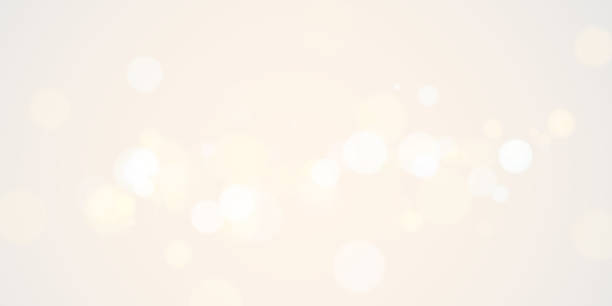 istock A soft and dreamy background featuring delicate white and golden bokeh lights on a light beige canvas, creating an atmosphere of warmth, elegance, and serenity—ideal for minimalist or festive designs. 2196150792