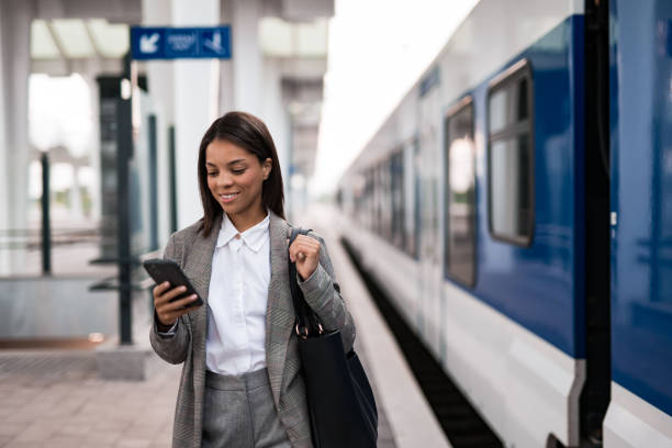 istock Young businesswoman using phone on railway station 2196150970