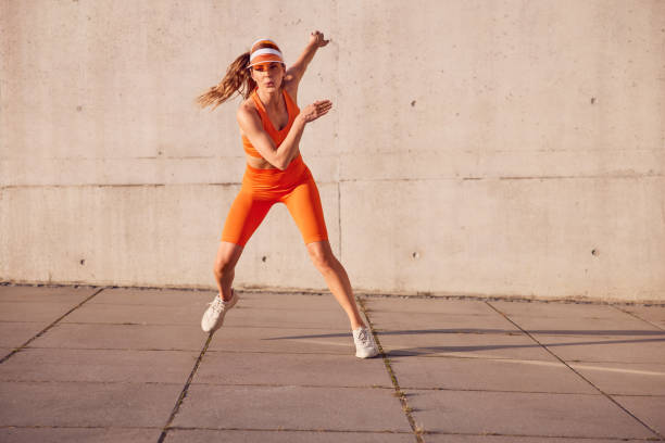 istock Fit woman doing interval workout outdoors against concrete wall 2196151914