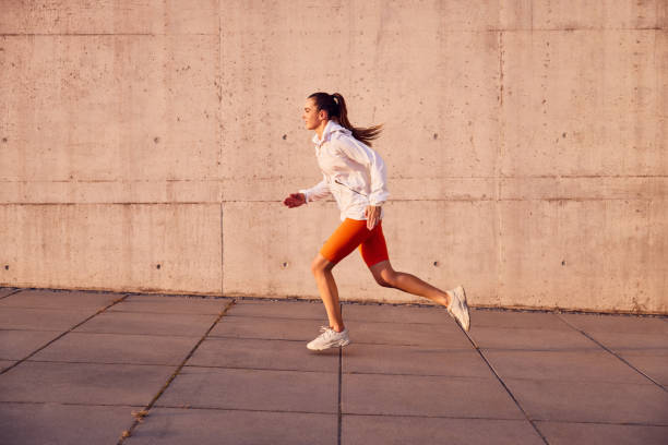 istock Athletic woman running outdoors 2196152089
