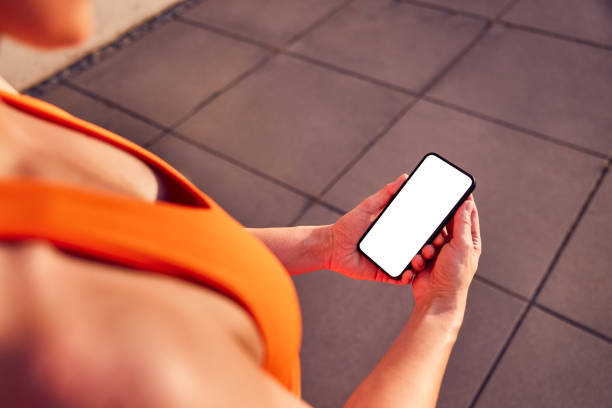 istock Fit woman holding mobile phone with  mock up blank screen 2196152200