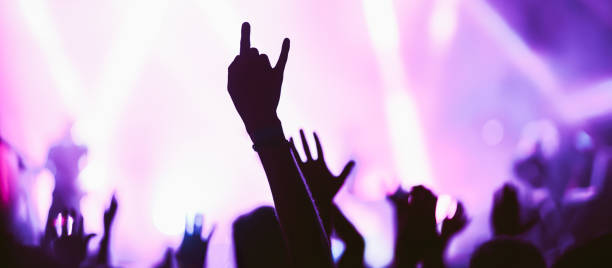 istock Crowd at concert. Stage lights and hands in the air. 2196152277