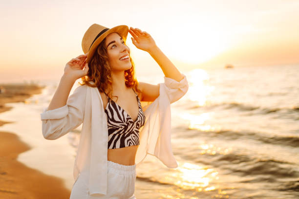 istock Young woman enjoys her vacation on the beach. 2196152714
