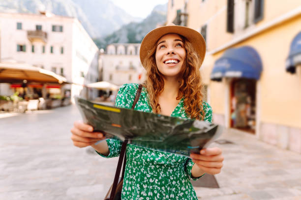 istock Adventurous woman navigating in with topographic map by city. 2196152816