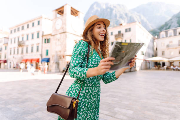 istock Adventurous woman navigating in with topographic map by city. 2196152833