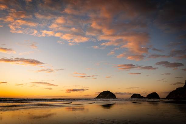 istock Serene beach sunset with colorful cloud reflections. 2196153507