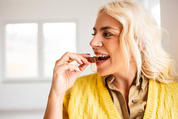 istock Happy Woman Savoring a Chocolate Treat 2196154162