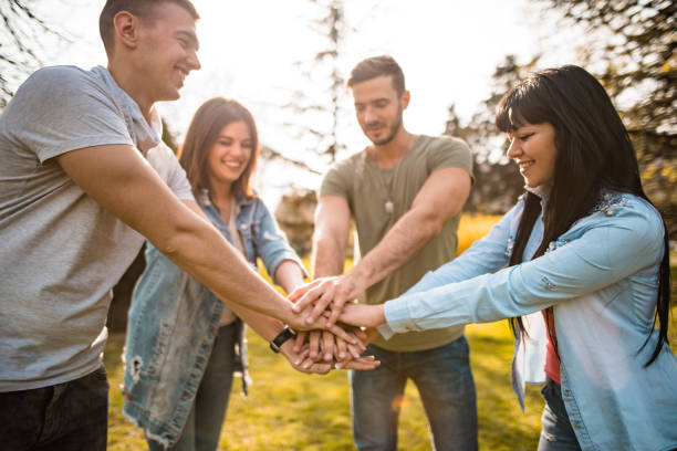 istock happiness friends with arm raised outdoors 2196155251
